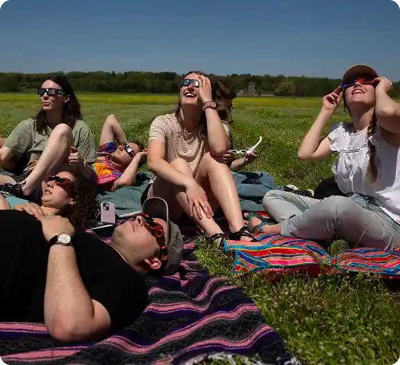 Group enjoying outdoor picnic after winning a Spectrum promotional picnic basket raffle.
